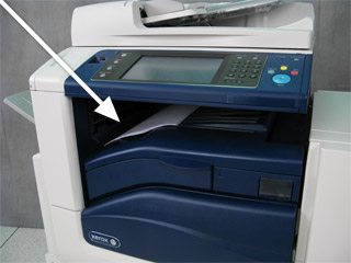 If paper is jammed at the exit to the Output Tray, remove the paper by carefully pulling it straight out